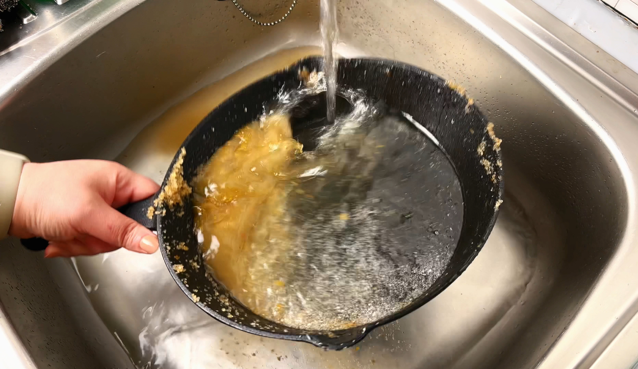 rinsing pan with water